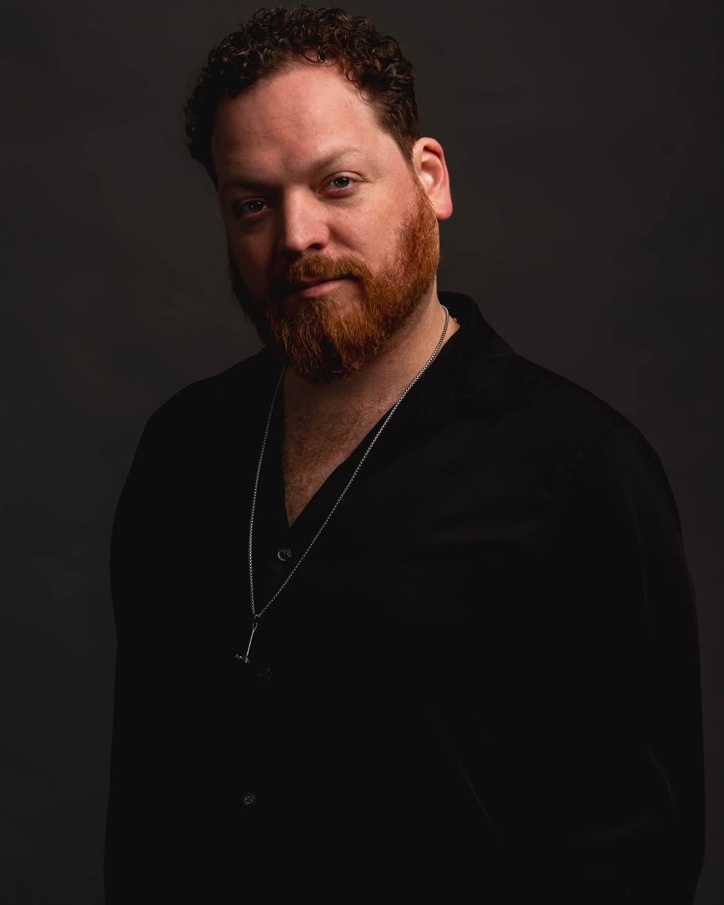 Dave Menzo, studio portrait against a dark backdrop